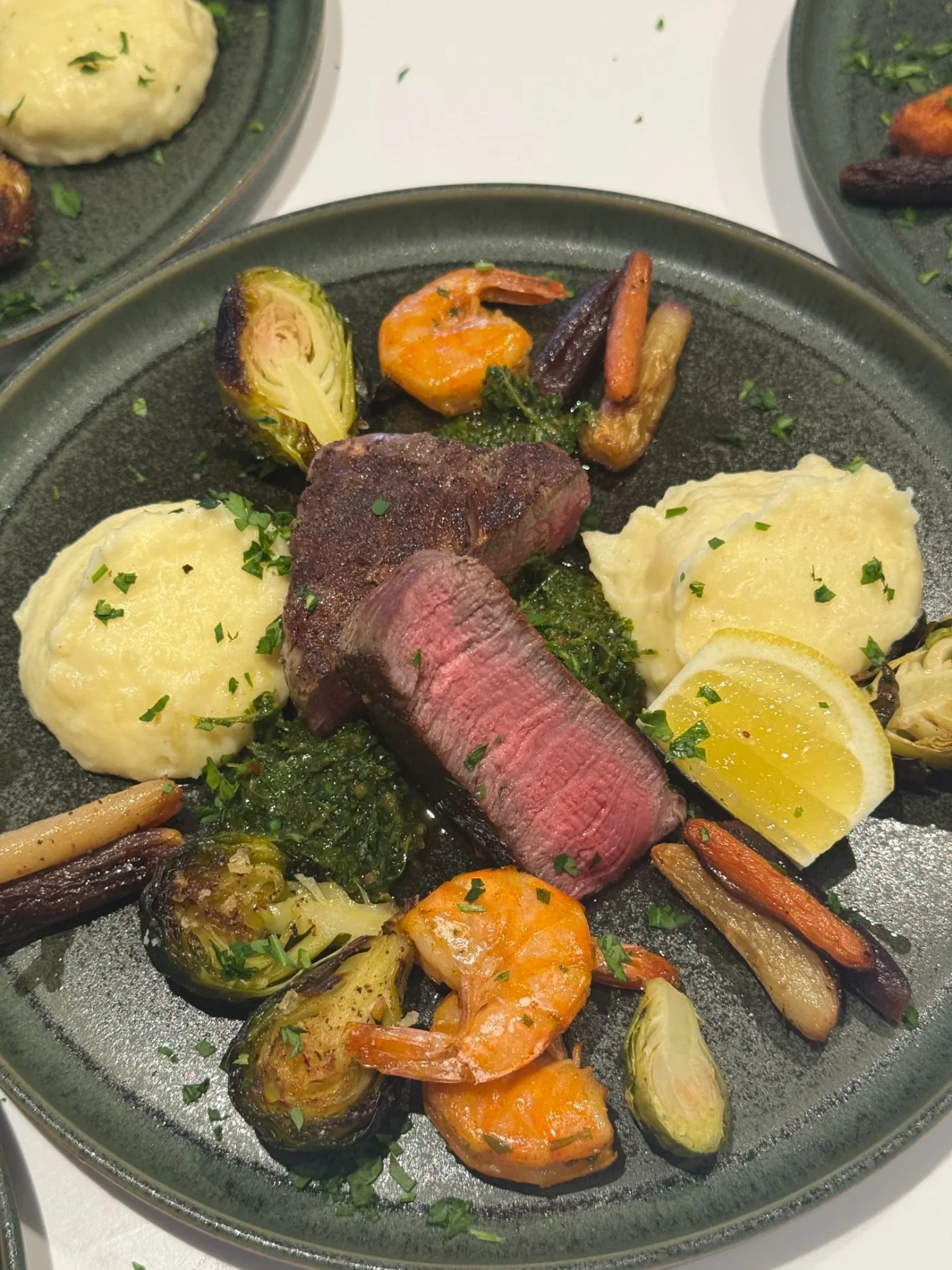 Seared steak with prawn, cauliflower purée and charred carrots