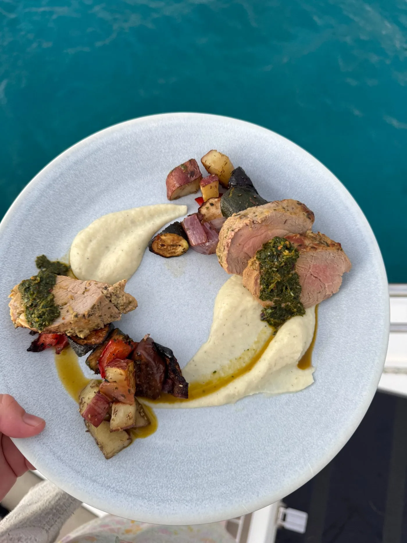 Pork tenderloin with cauliflower purée and salsa verde, served over the rail