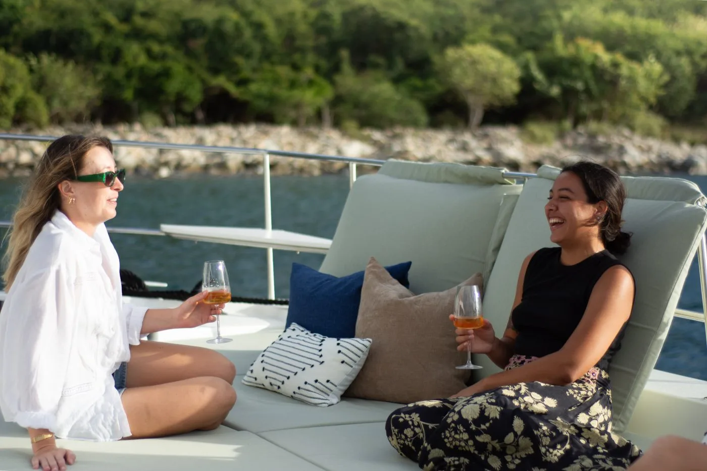 Guests sharing drinks and laughter aboard Allegra