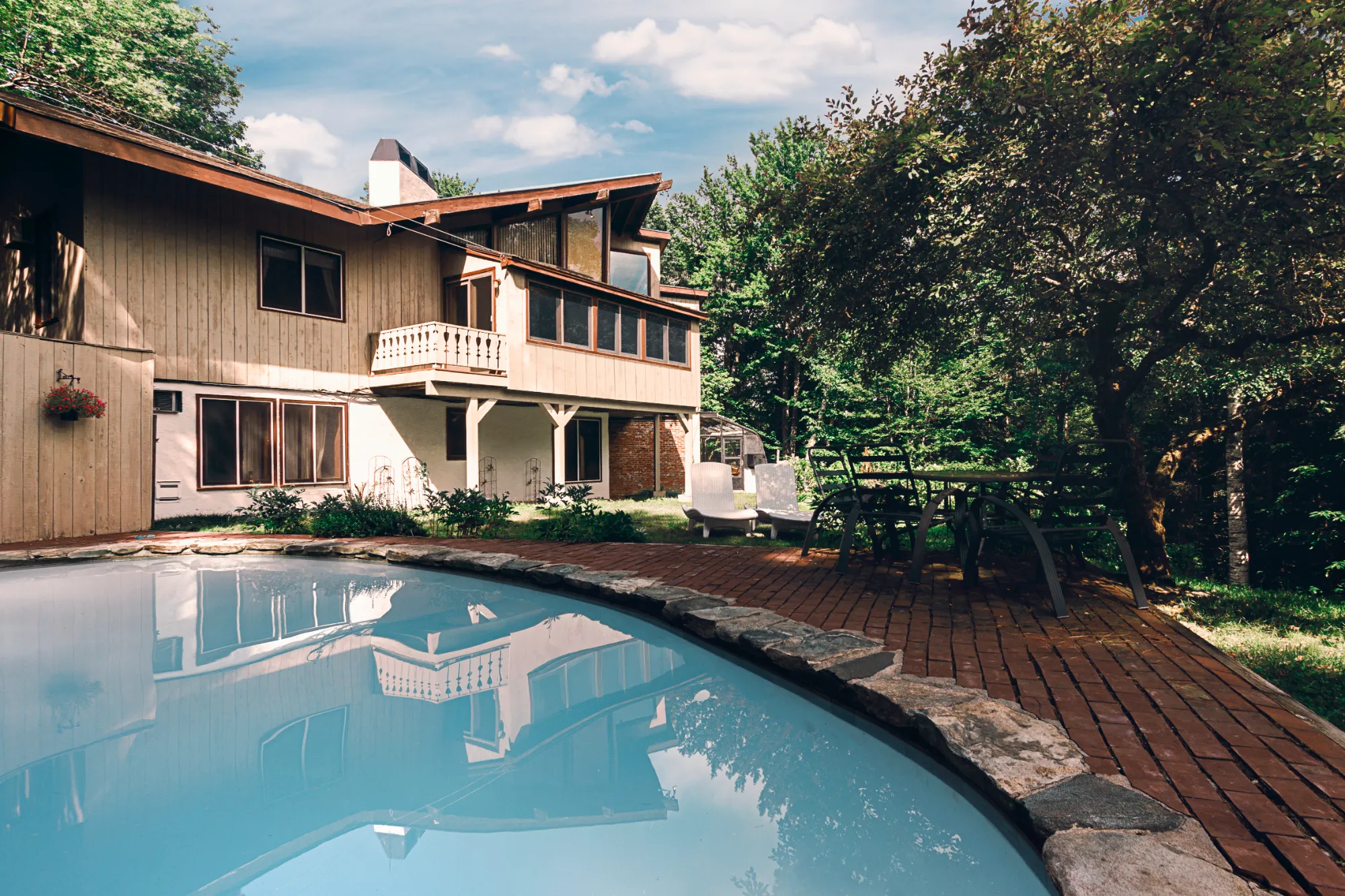 Paradise Vermont Chalet — secluded chalet with heated outdoor pool, brick patio, and surrounding woods near Stratton Mountain